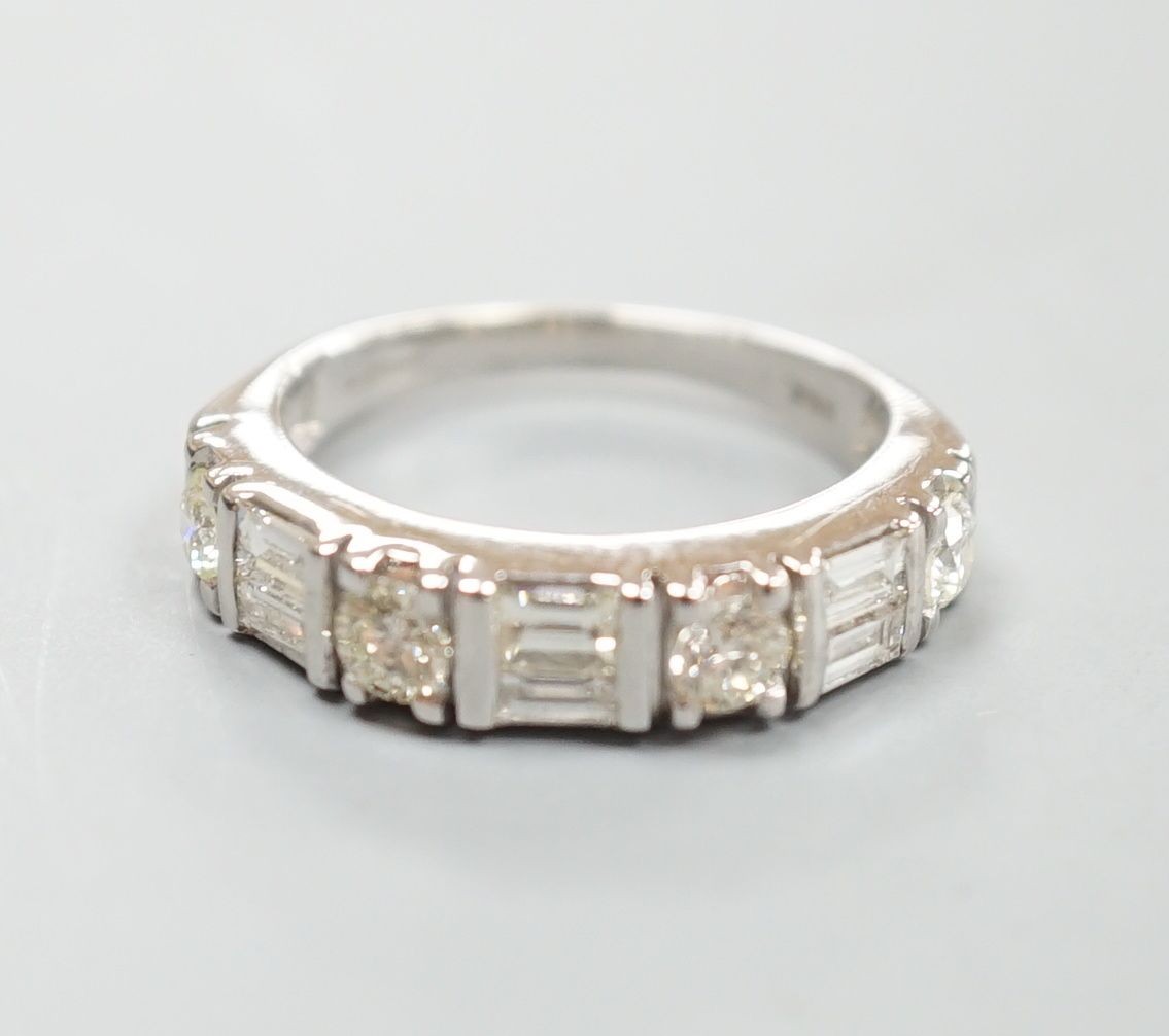 A modern 14ct gold, baguette and round cut diamond set half hoop ring, size K, gross weight 3.9 grams.